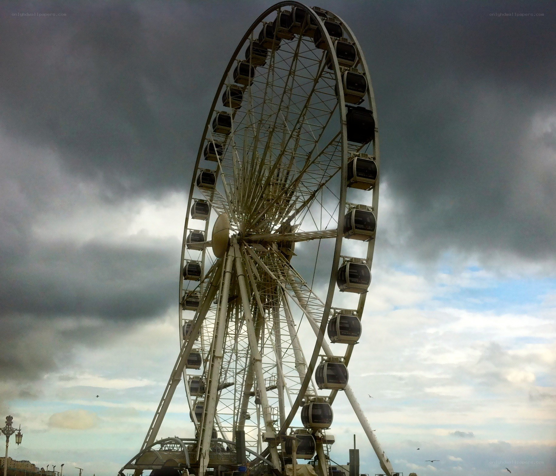 Ferris wheel under stormy sky
