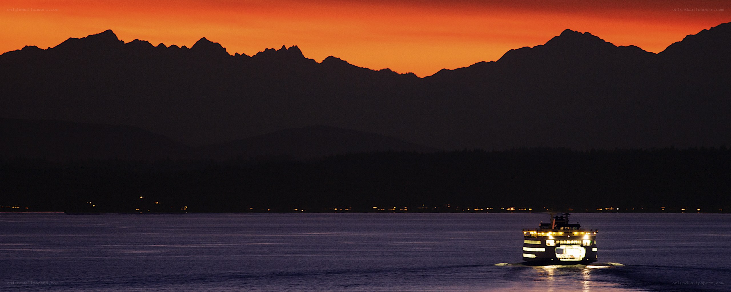 Ferry at sunset with mountains