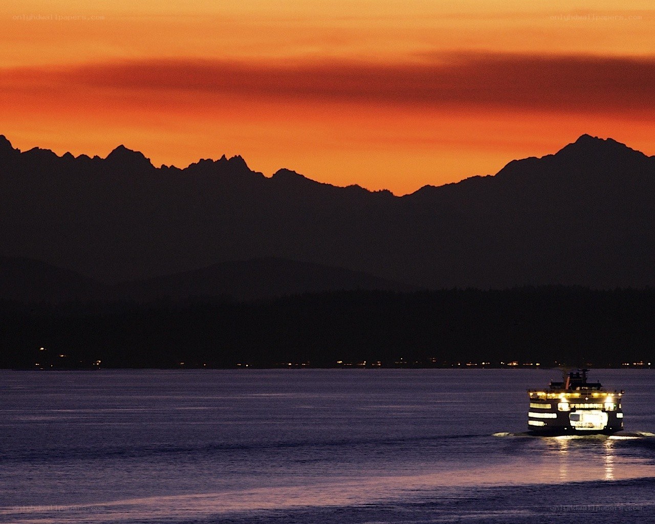 Ferry at sunset with mountains