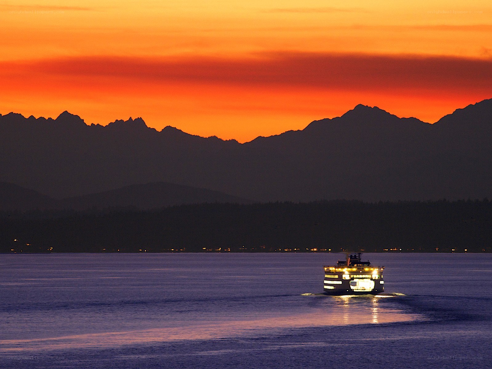 Ferry at sunset with mountains