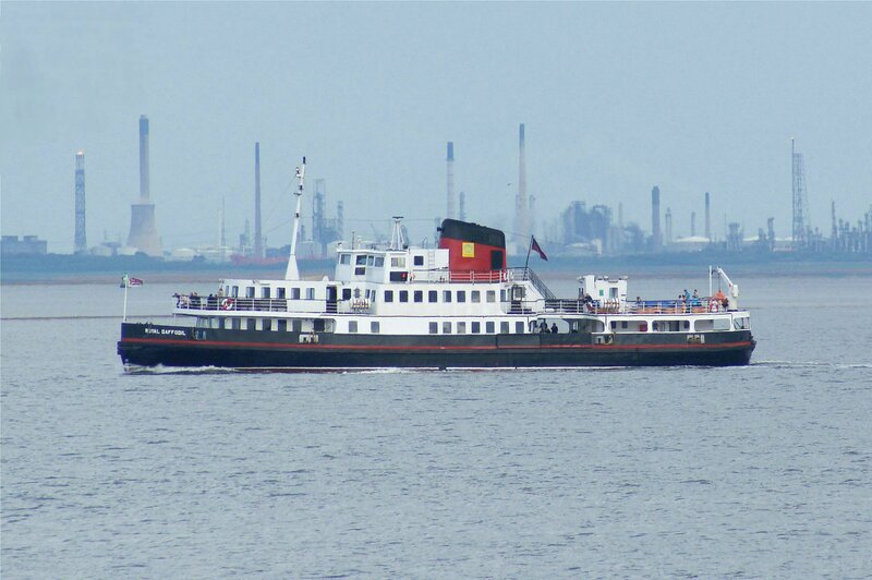 Ferry on a river with industrial background