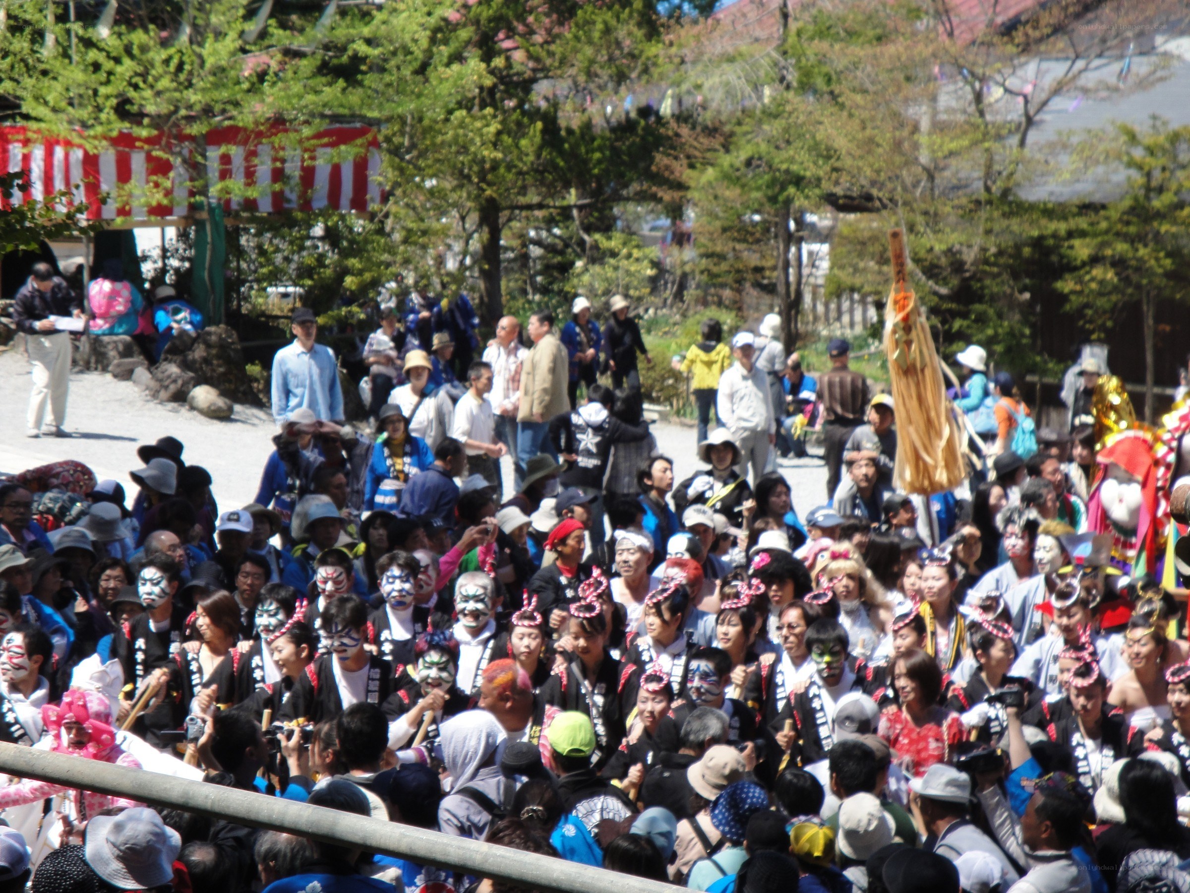 Festival crowd with masked performers
