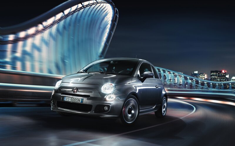 Fiat 500 on city bridge at night