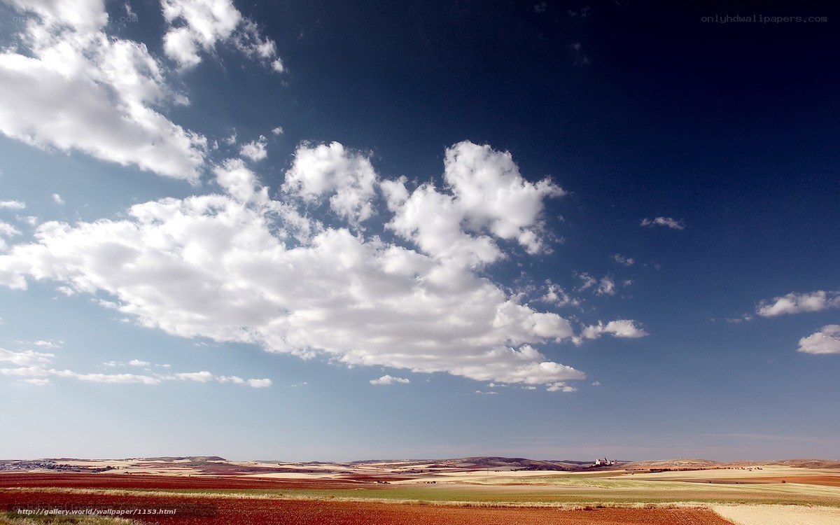 Fields under a cloudy sky