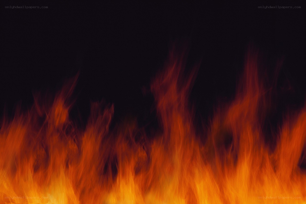 Fiery flames against black background