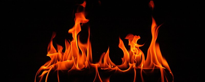 Fiery flames against black background