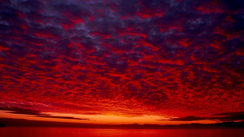Fiery red sunset over water