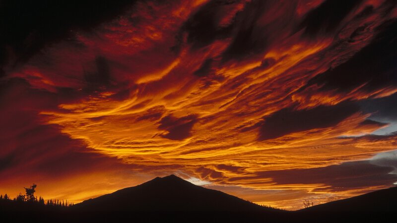 Fiery sunset over mountain silhouette