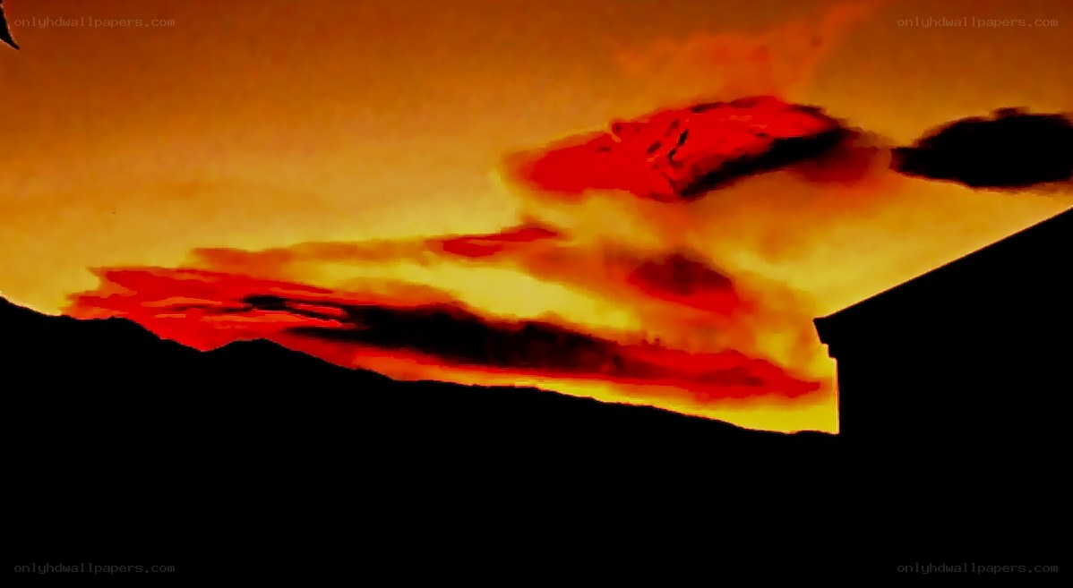 Fiery sunset over silhouetted landscape