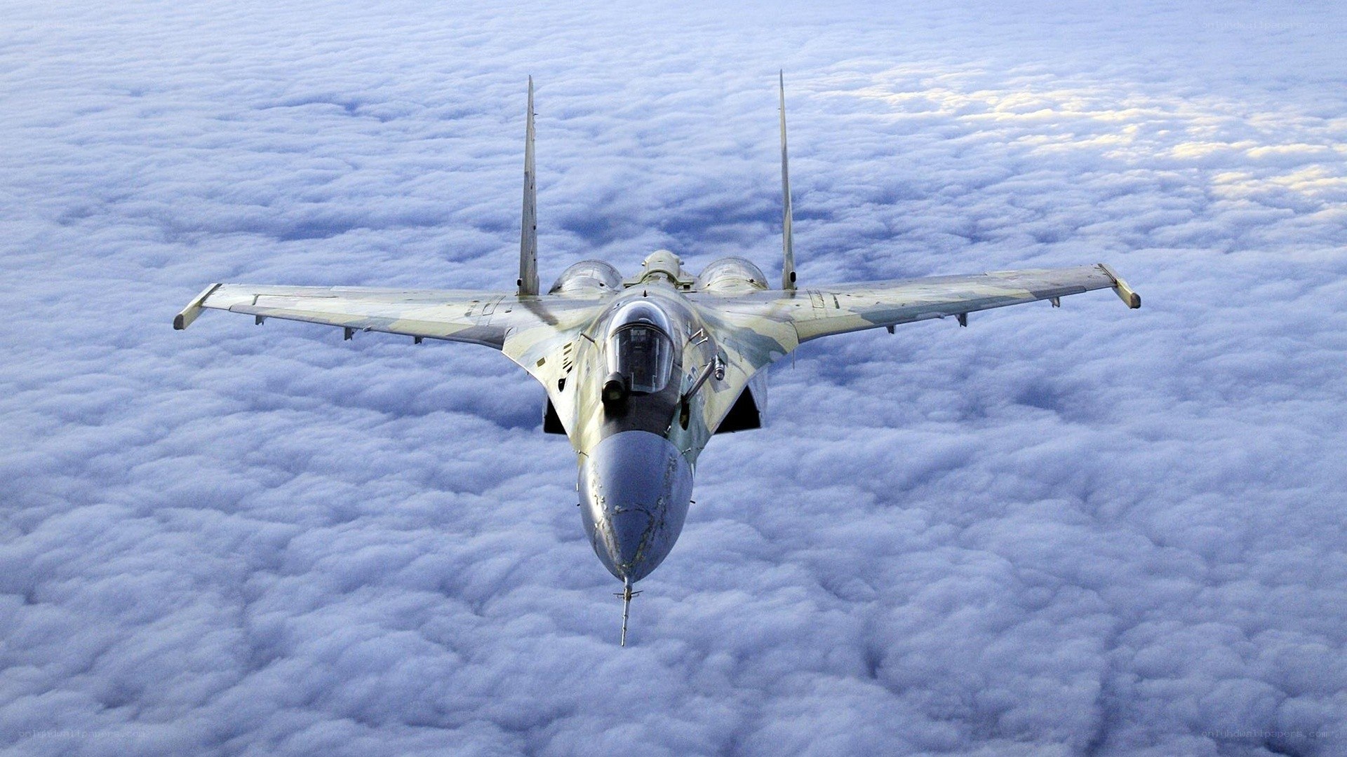 fighter jet above clouds