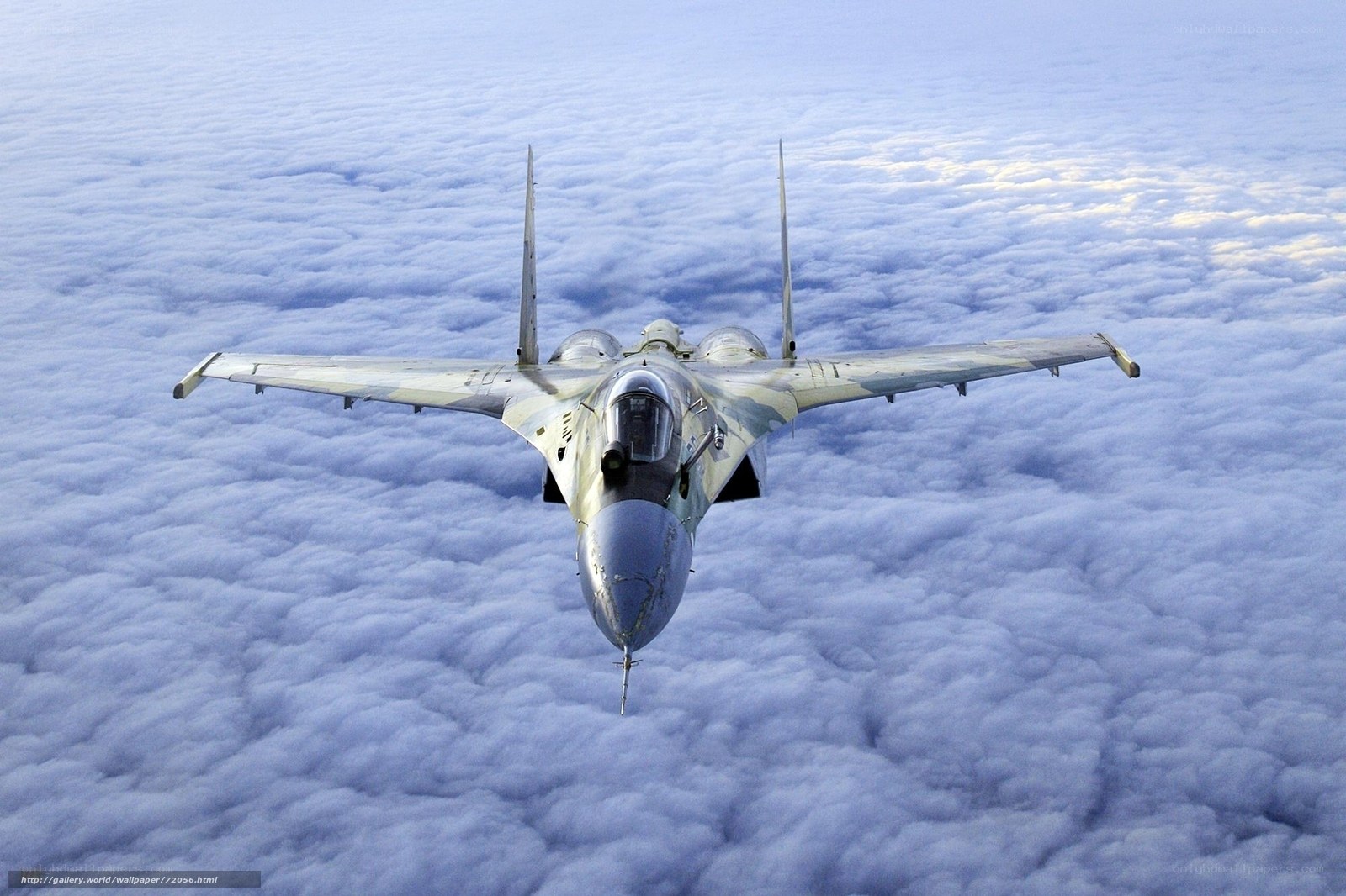 fighter jet above clouds