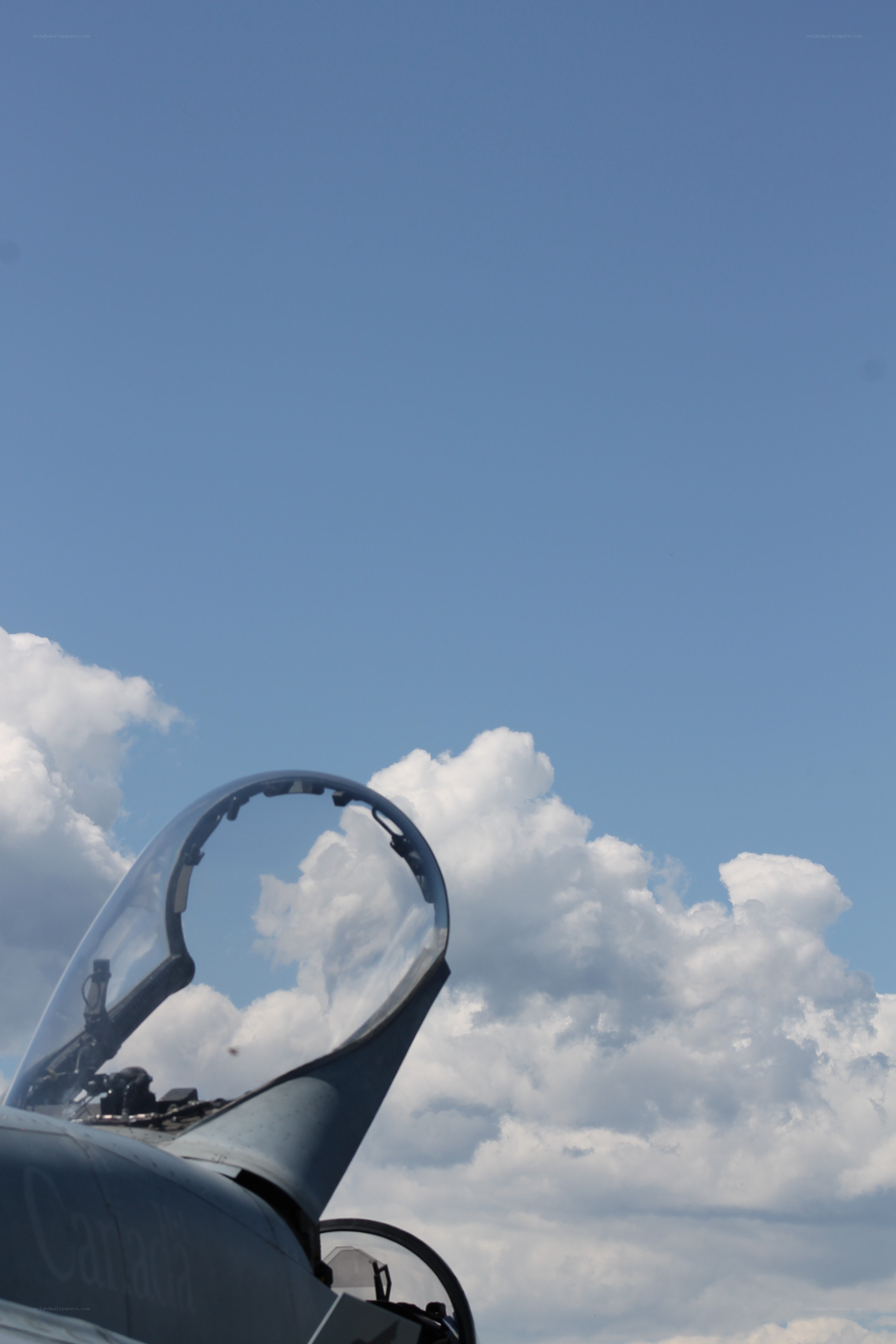 fighter jet cockpit against sky