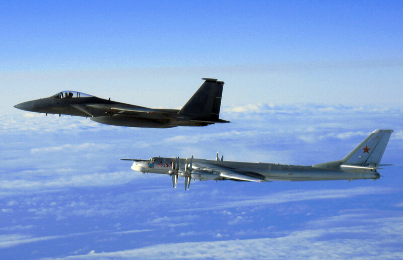 Fighter jet escorting bomber
