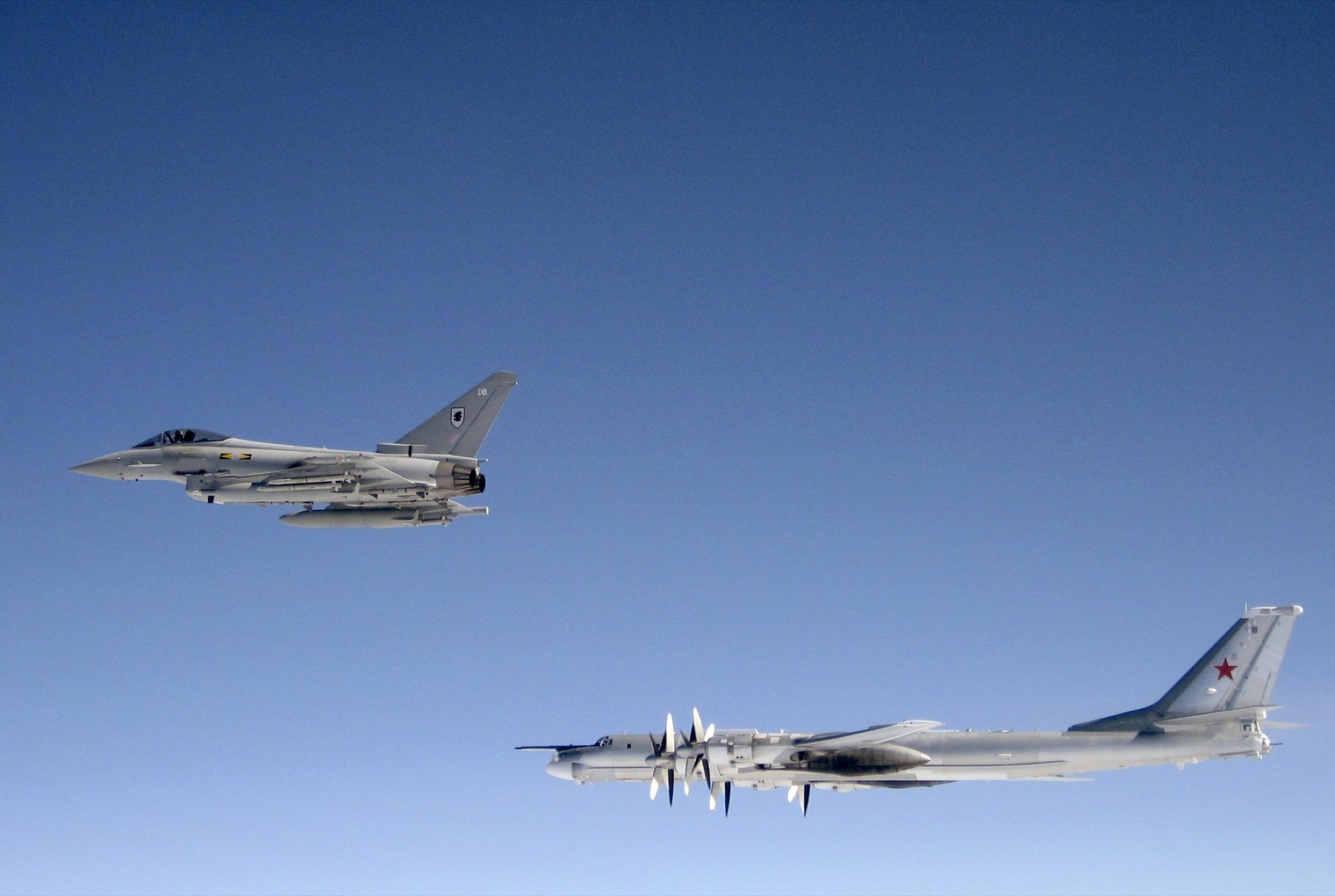 Fighter jet escorting bomber