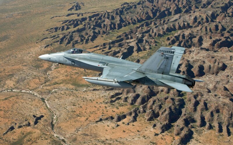 Fighter Jet in Flight — Gray, Dramatic, Afternoon, Photograph, Mountainous Terrain