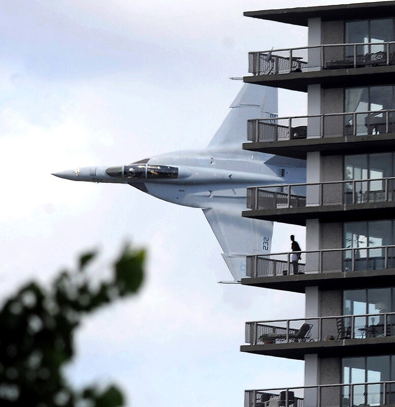 Fighter jet near apartment building