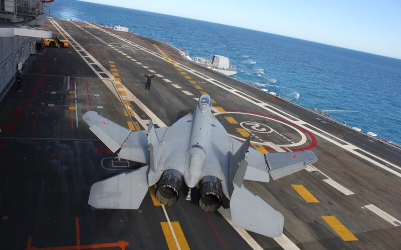 Fighter Jet on Aircraft Carrier — Person