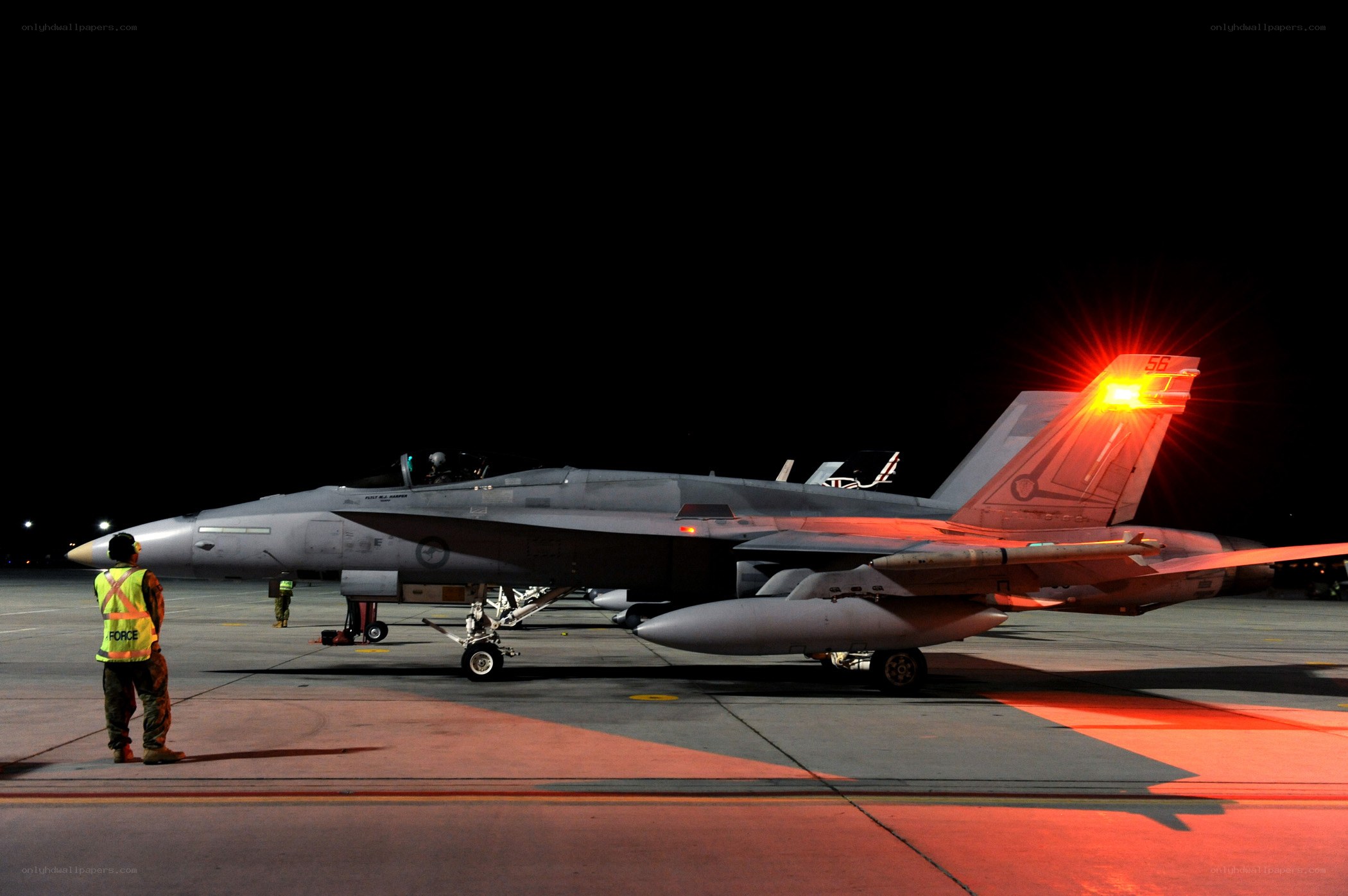 Fighter jet on tarmac at night