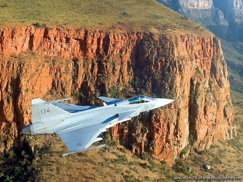 fighter jet over canyon