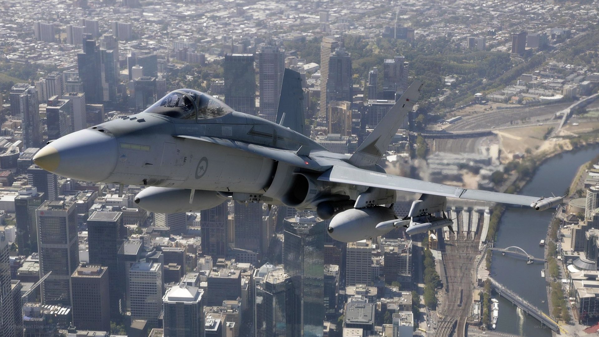 fighter jet over city