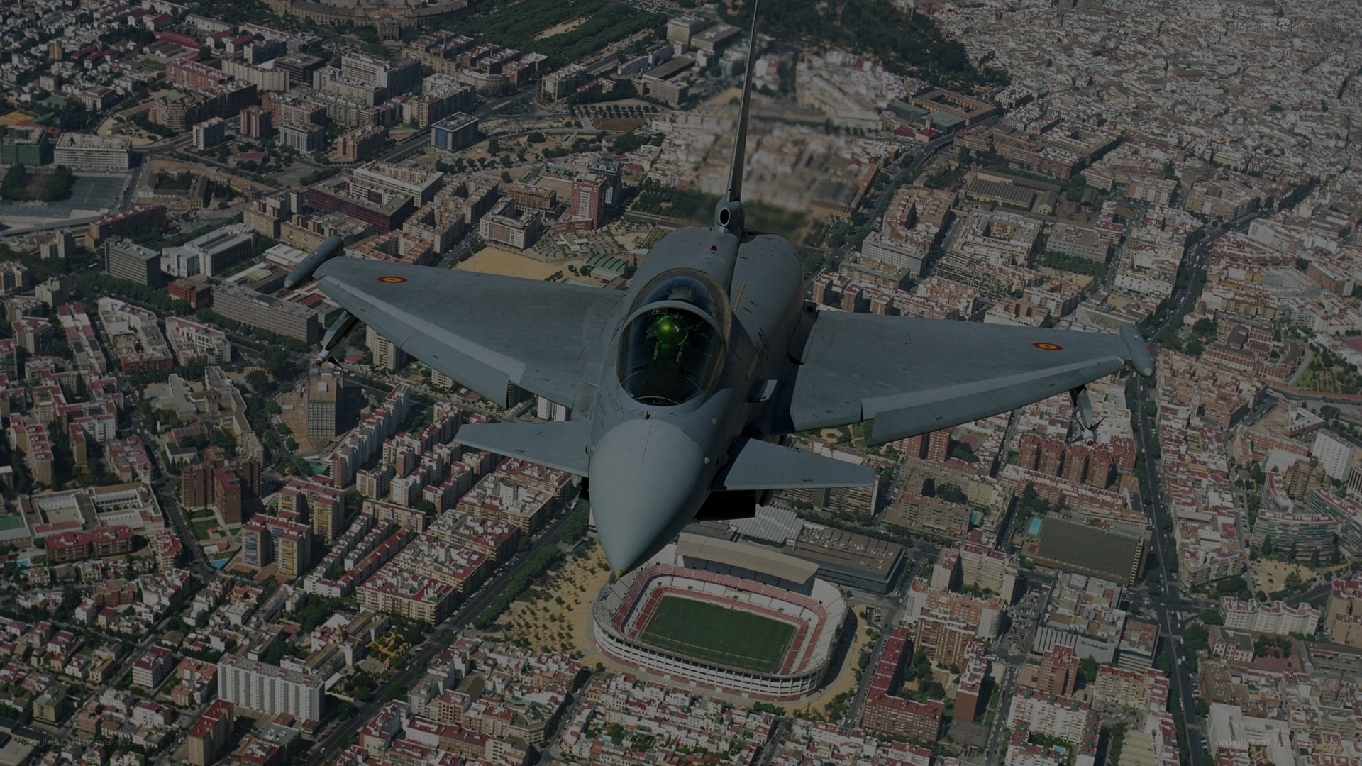 fighter jet over city