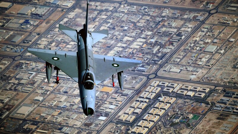 Fighter jet over city