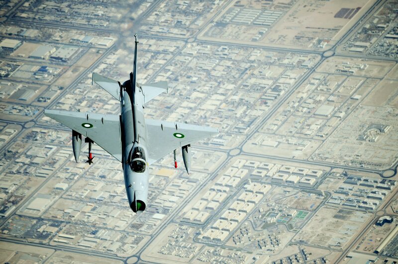 fighter jet over city