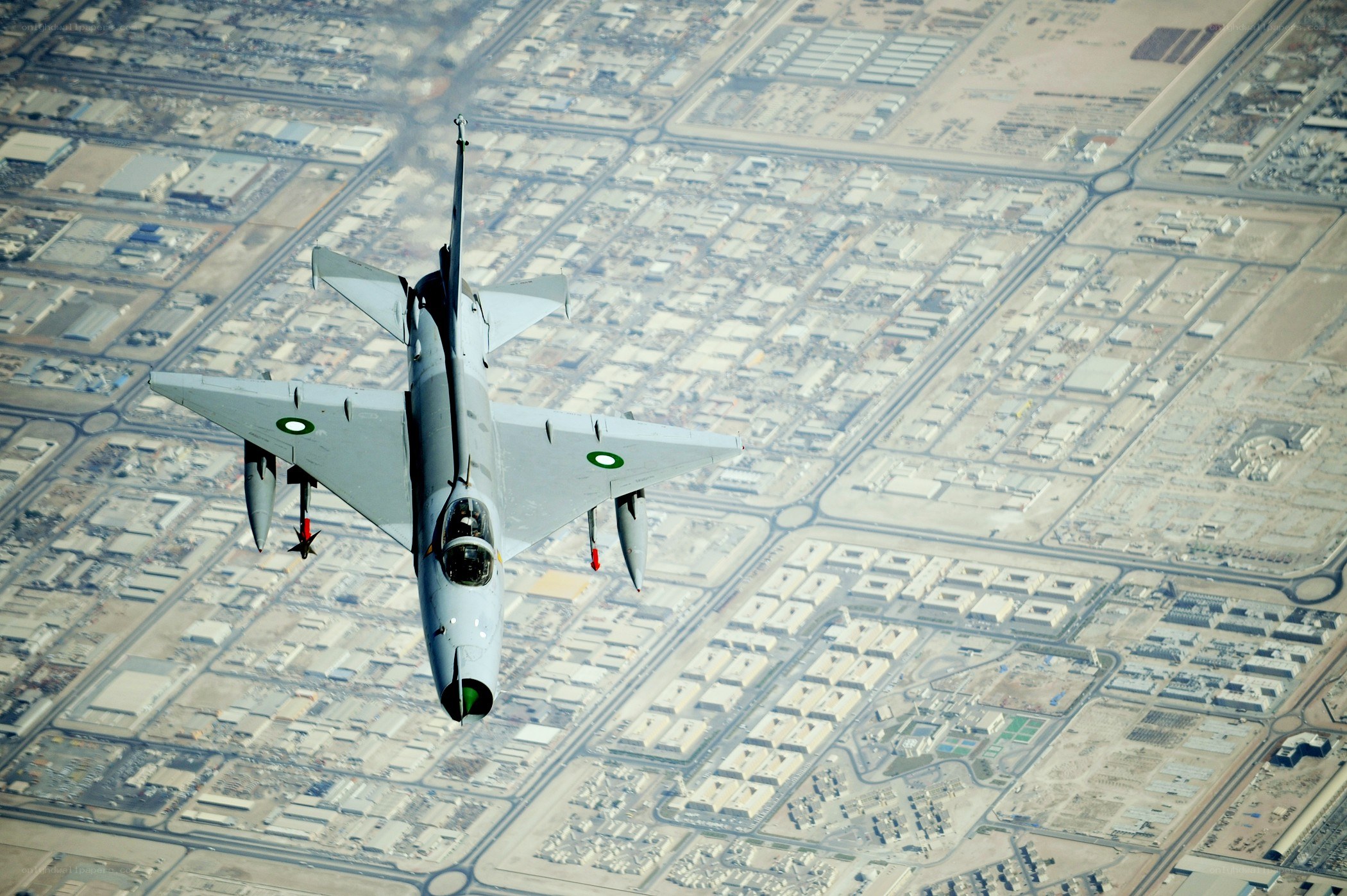 fighter jet over city