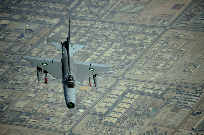 fighter jet over city