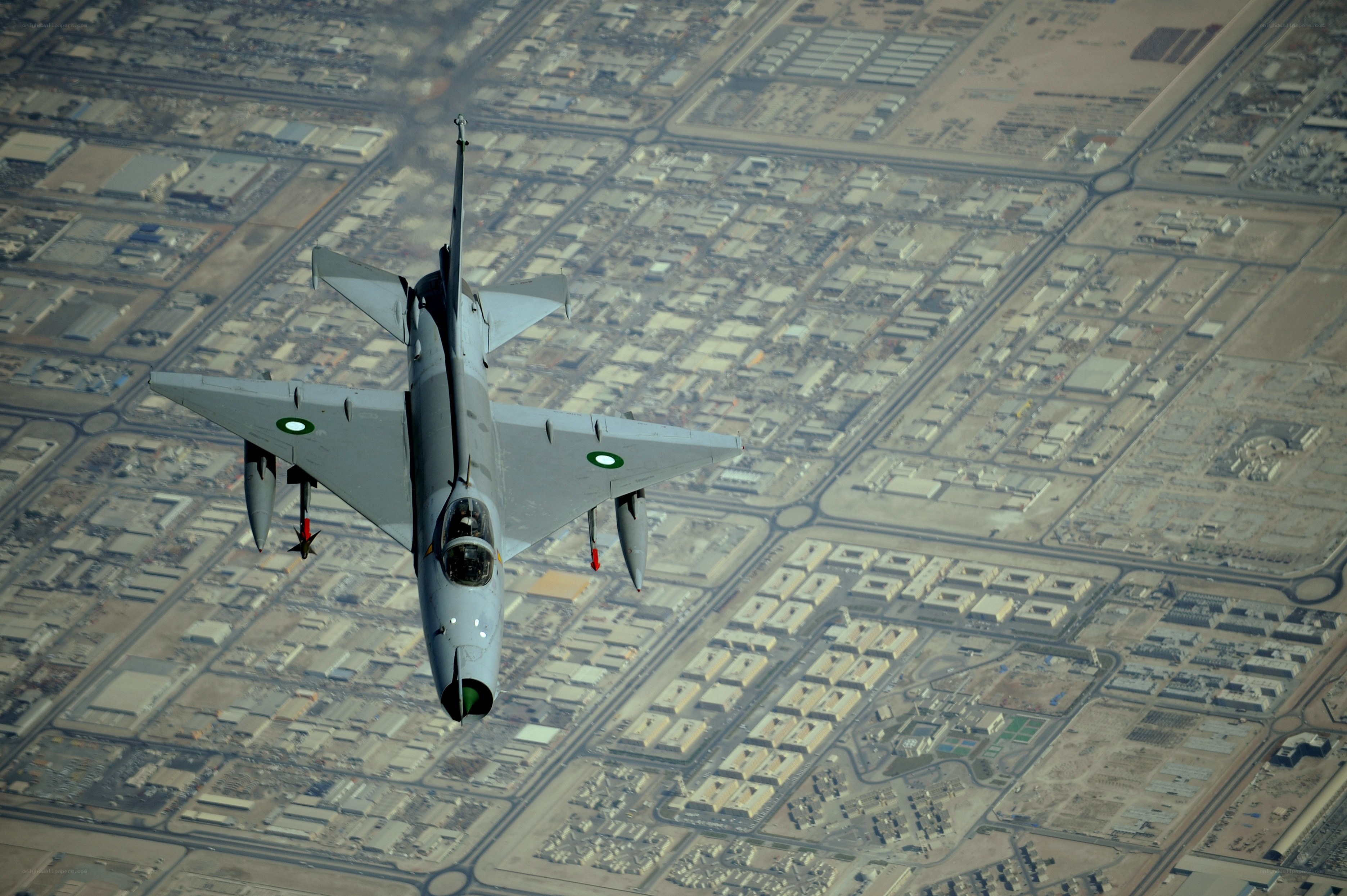 fighter jet over city