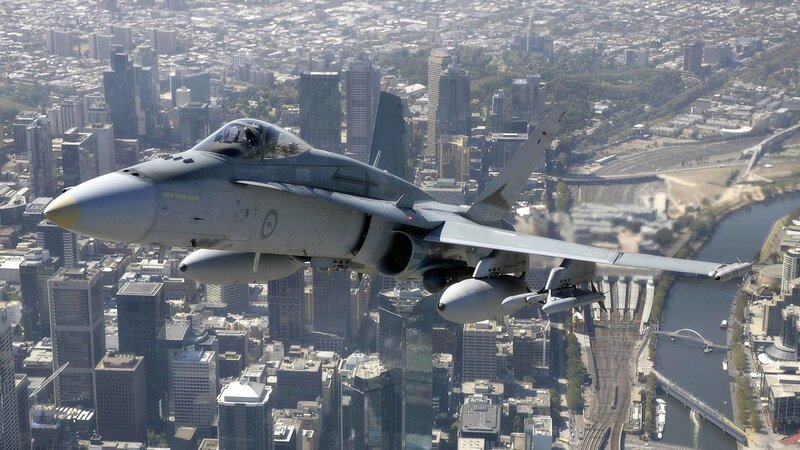 Fighter Jet over City — Gray, Dramatic