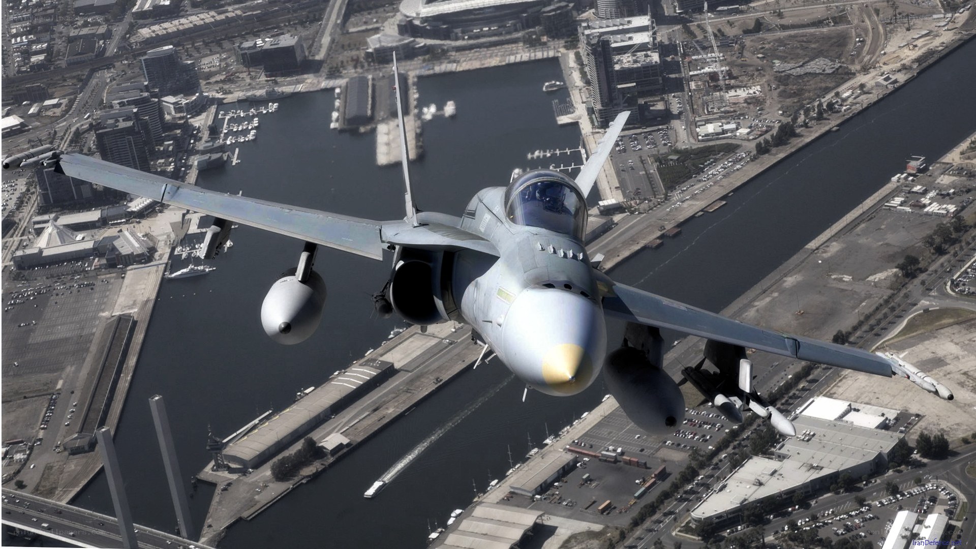 fighter jet over city harbor