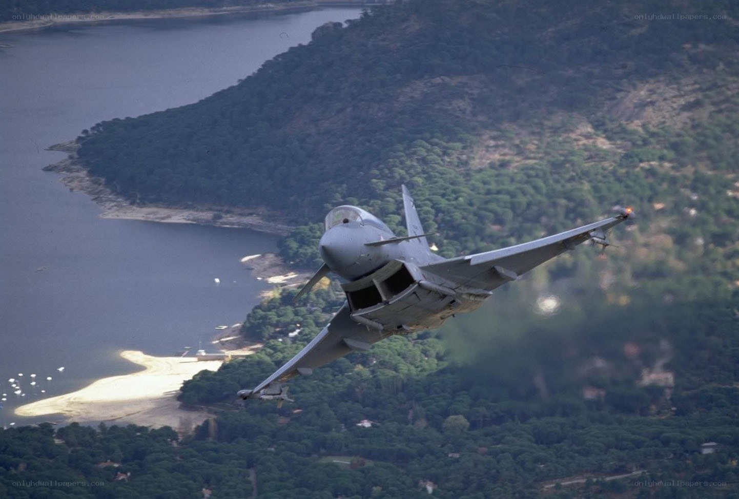 fighter jet over coastal landscape