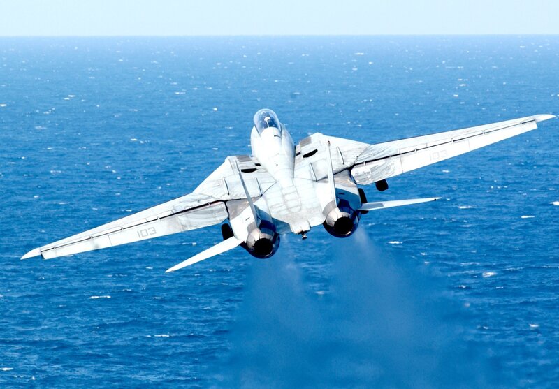 fighter jet over ocean