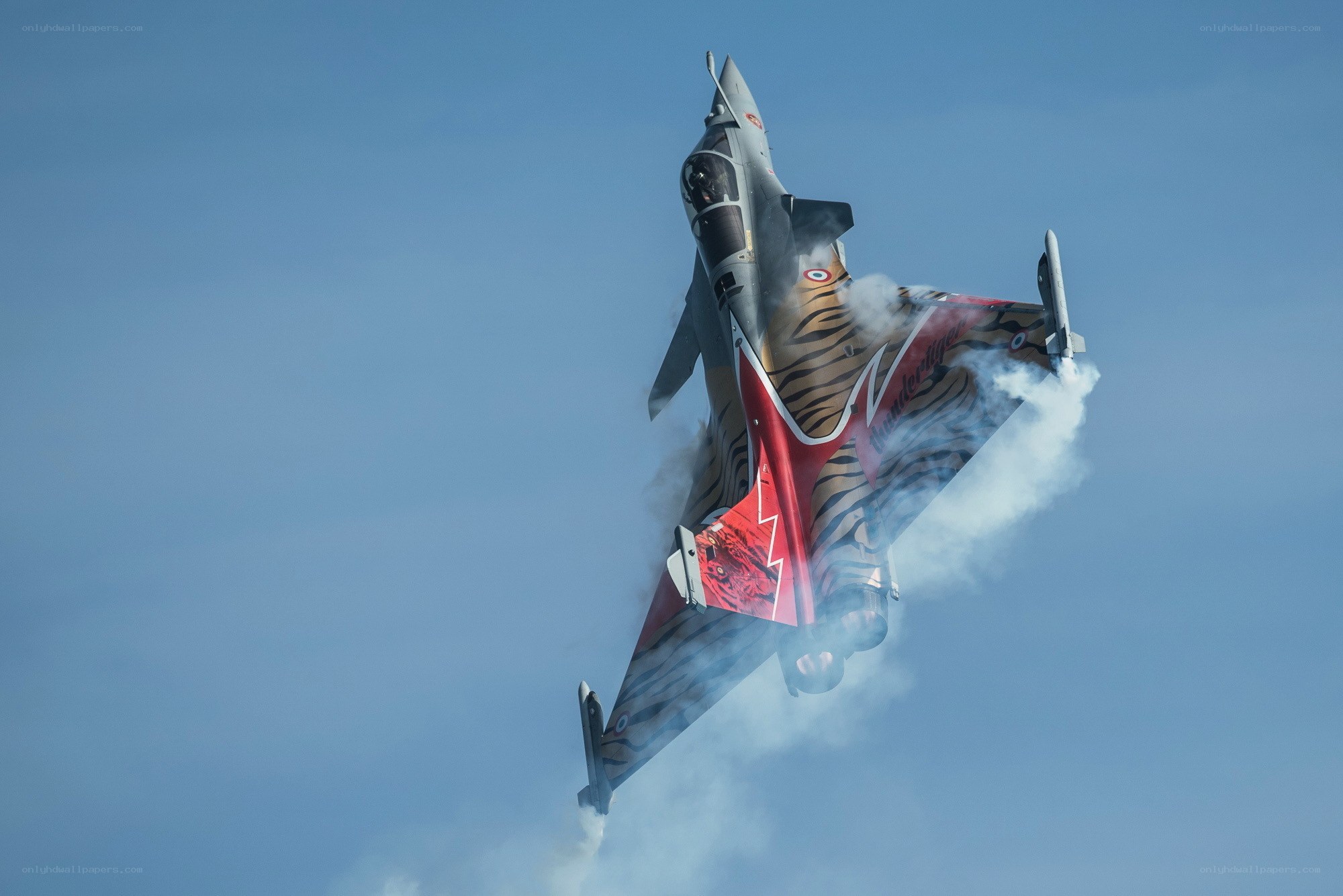 fighter jet performing aerobatic maneuver