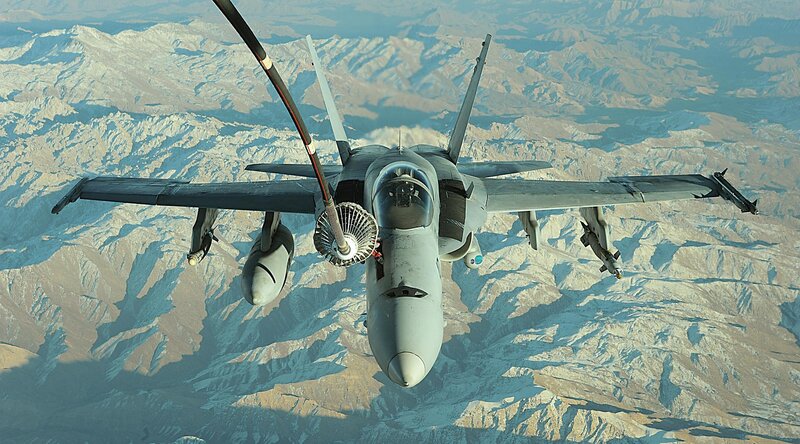 fighter jet refueling over mountains