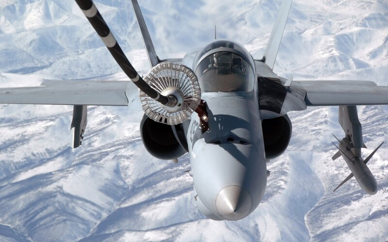 fighter jet refueling over snow