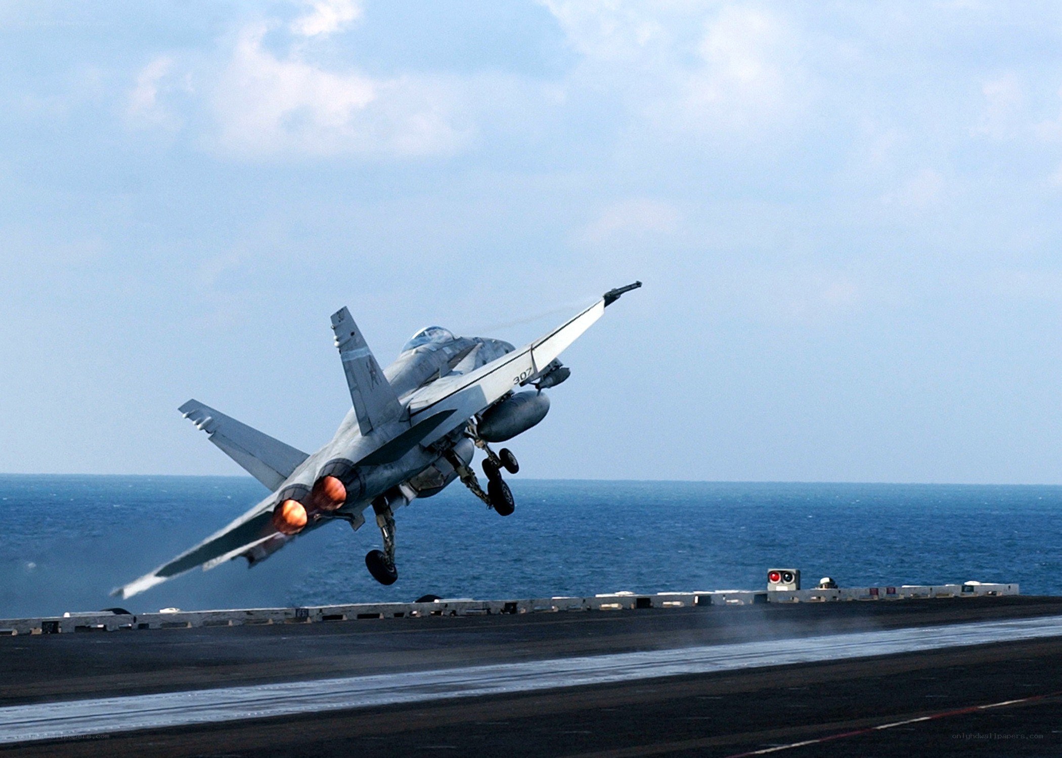 fighter jet taking off from aircraft carrier