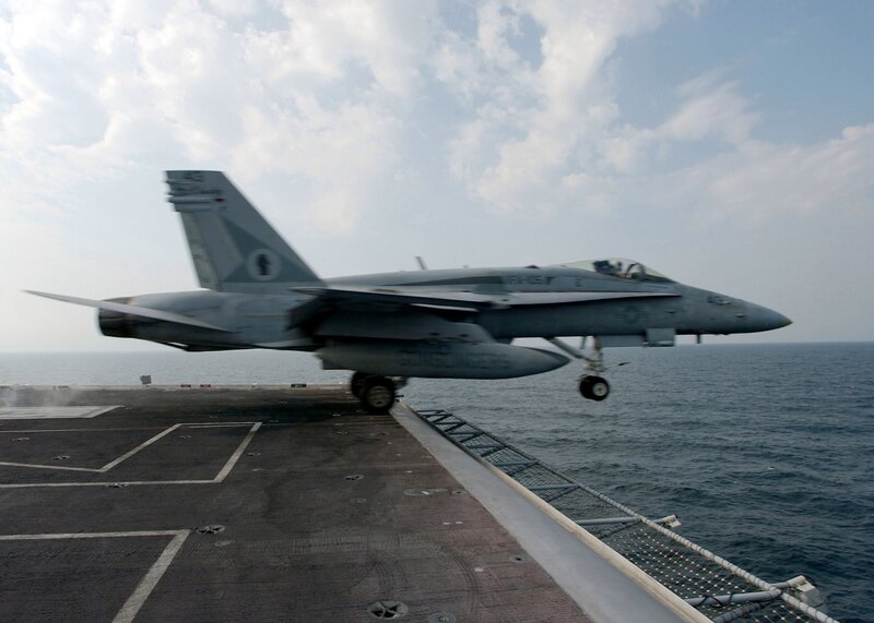 fighter jet taking off from aircraft carrier