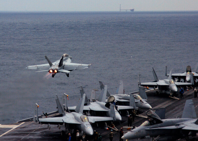 Fighter jet taking off from aircraft carrier