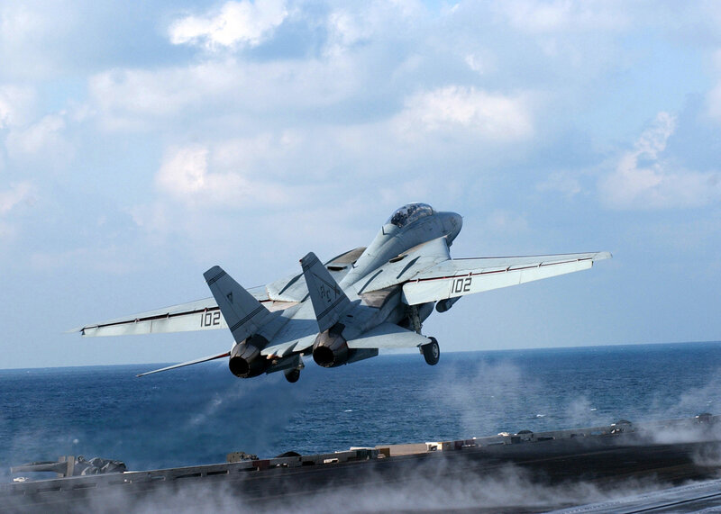 fighter jet taking off from aircraft carrier