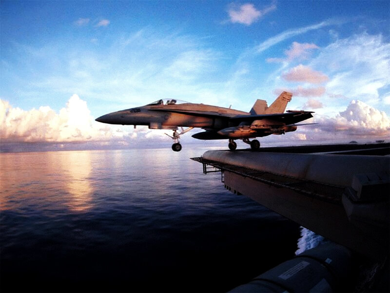 Fighter jet taking off from aircraft carrier