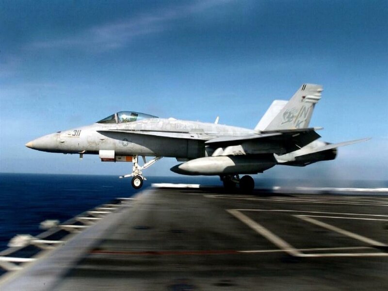 fighter jet taking off from aircraft carrier
