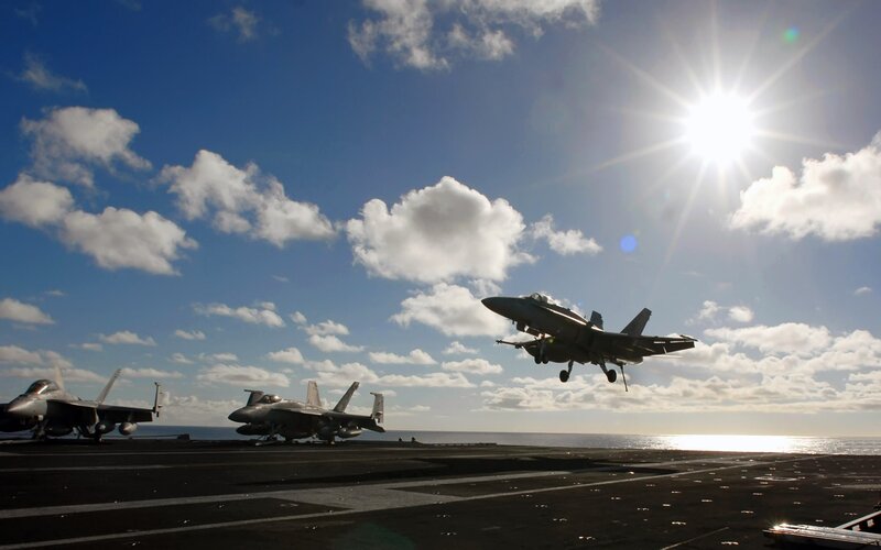 Fighter jet taking off from aircraft carrier