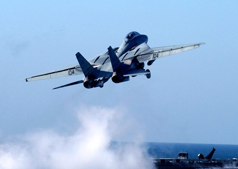 fighter jet taking off from aircraft carrier