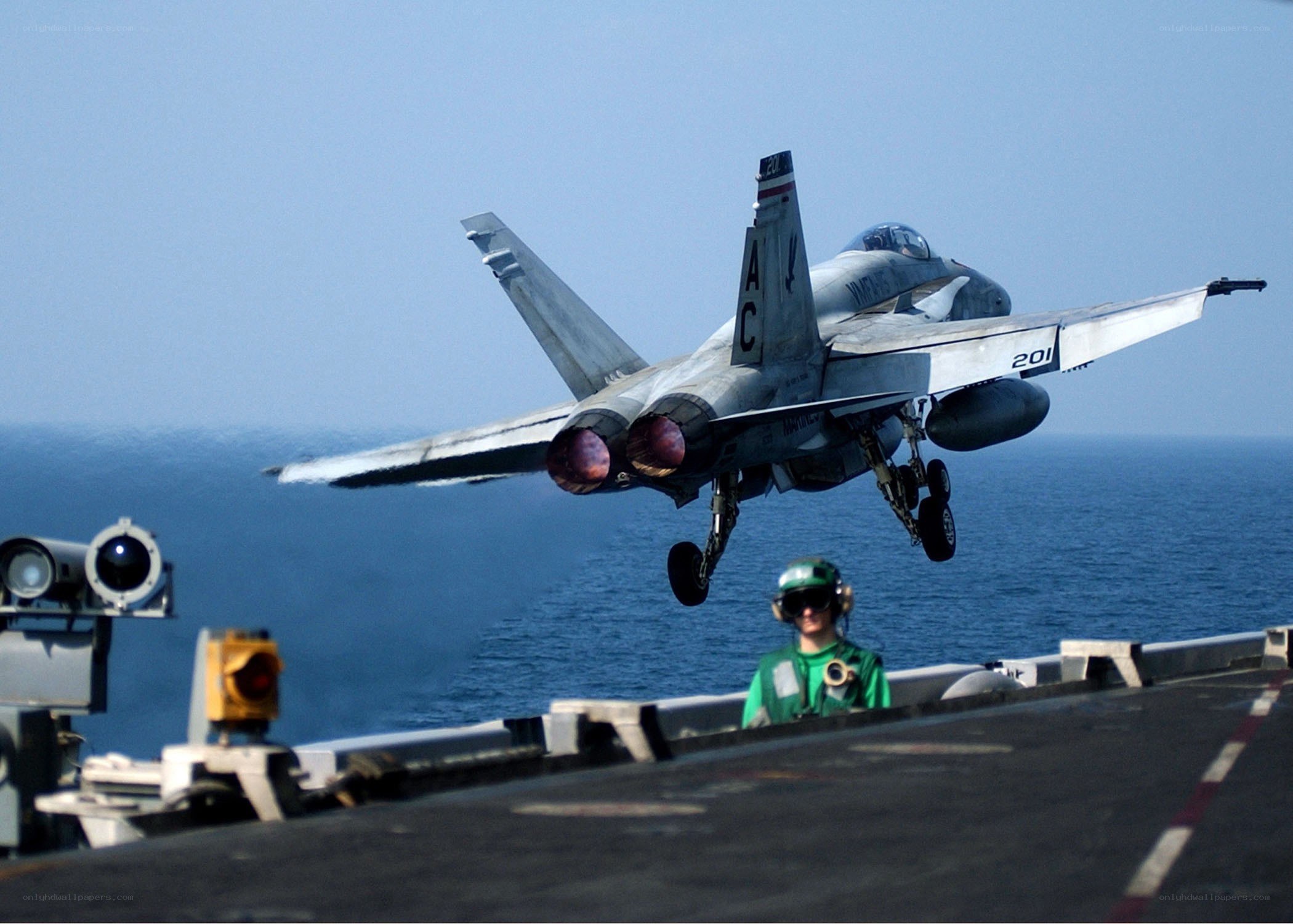 Fighter jet taking off from aircraft carrier