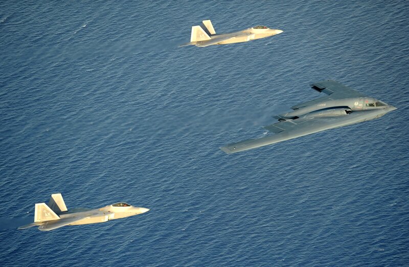 Fighter jets escorting a bomber