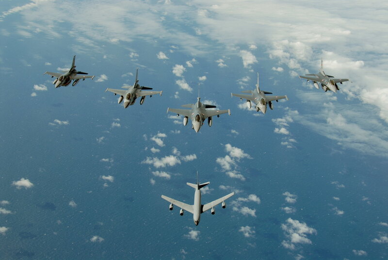 Fighter jets escorting a tanker