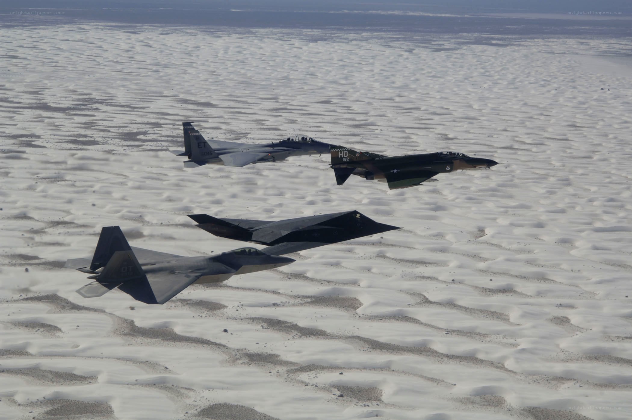 Fighter jets flying over desert