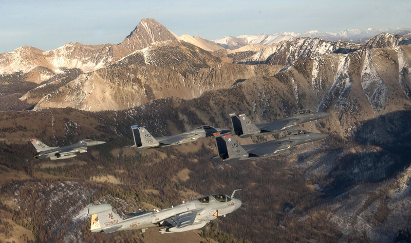 Fighter jets flying over mountains